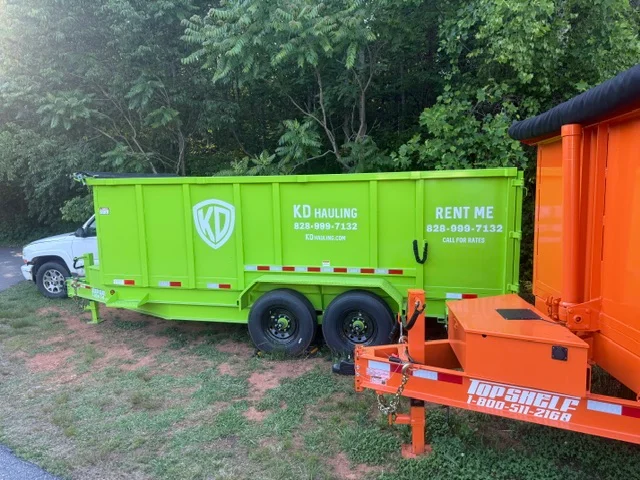 Lime-green dual-axle hauling trailer with reflective striping and orange equipment trailer on grass