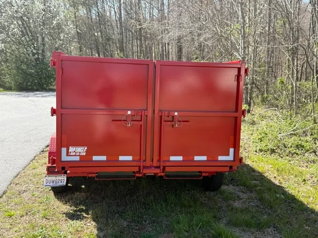 Red dual-door hauling trailer with reflective striping and heavy-duty latches