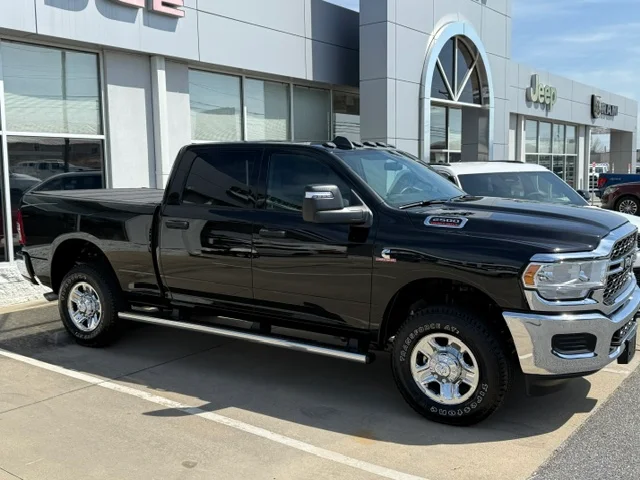 Black pickup truck with polished exterior and chrome accents in commercial lot