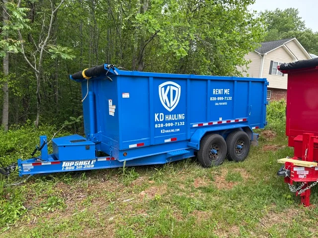 Blue dumpster trailer with dual axles, steel construction, and tow hitch for junk removal
