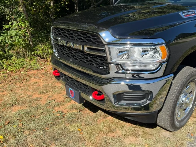 Black pickup truck with custom grille, LED headlights, and red fog light trim details